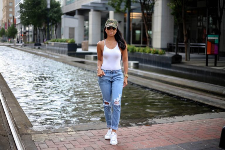 Woman in ripped jeans and bodysuit