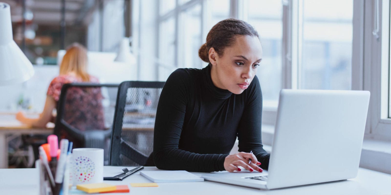 Young business executive using laptop