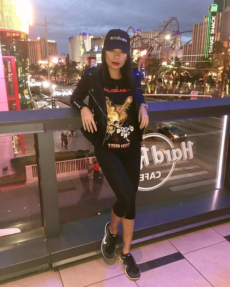 Woman poses with city skyline