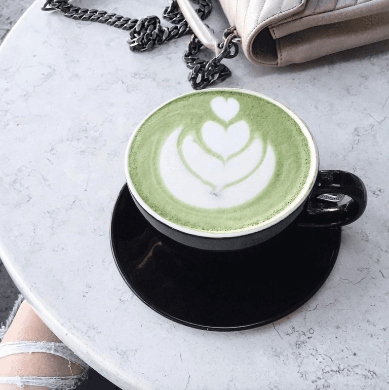 Matcha latte art in black cup