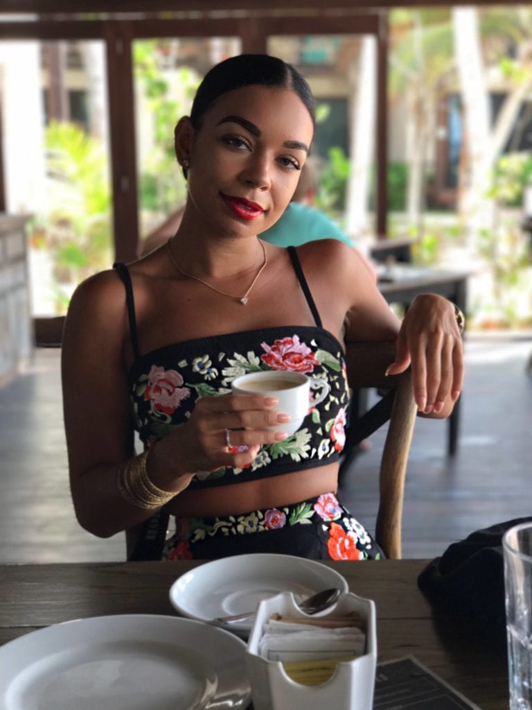 Woman holding coffee cup.