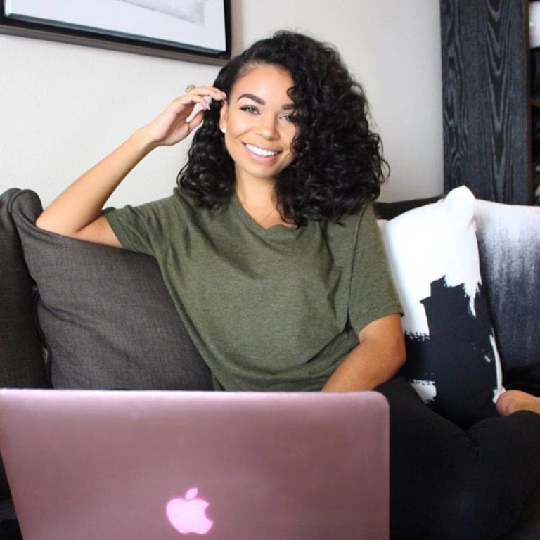 Woman on couch with laptop.