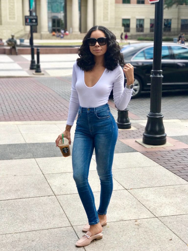 Woman in jeans holding coffee