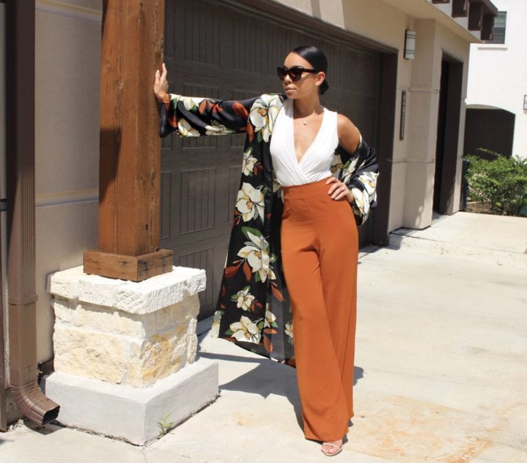 woman in floral duster and orange pants