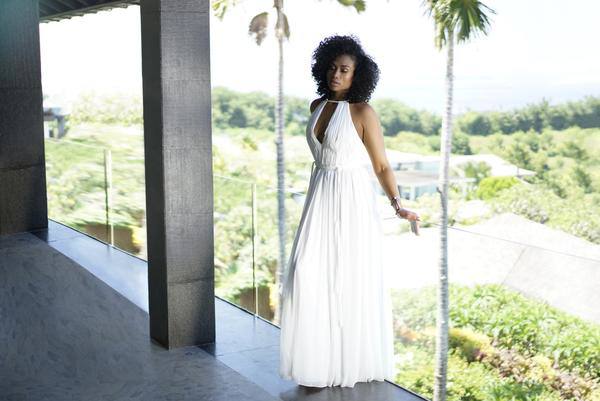 Woman in white dress outside.