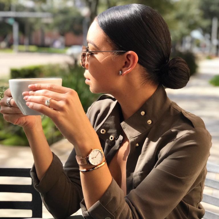 Woman enjoying coffee outdoors.
