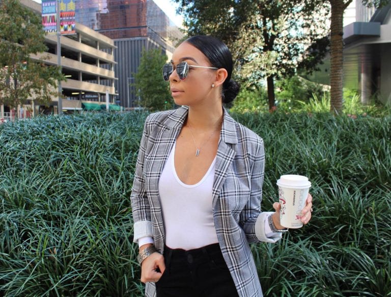 Woman in plaid blazer with coffee