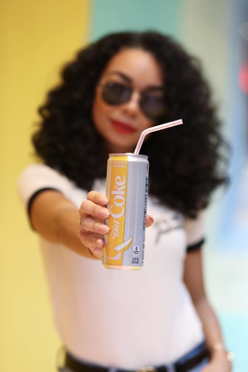Woman holds Diet Coke can