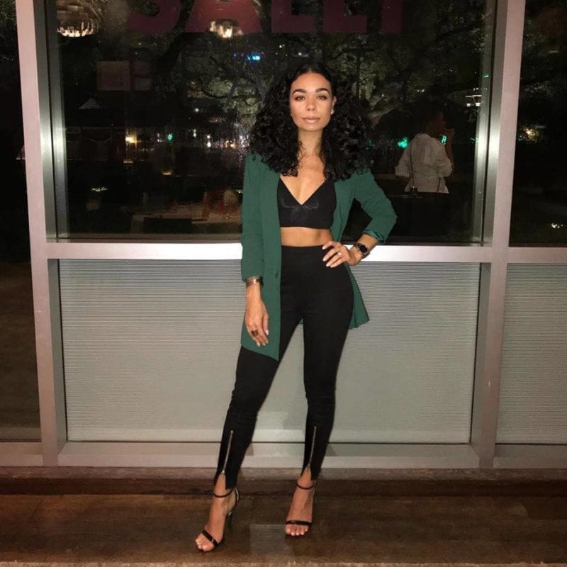 Woman in green blazer and black pants