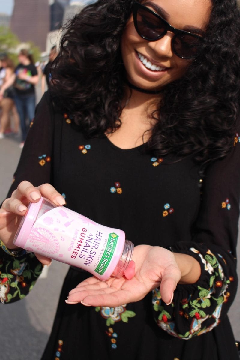 Woman pouring hair skin nails gummies