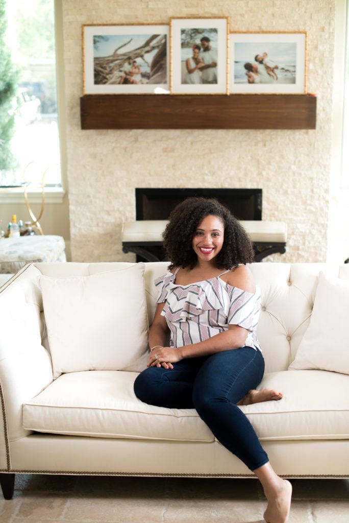 Woman sitting on cream couch.