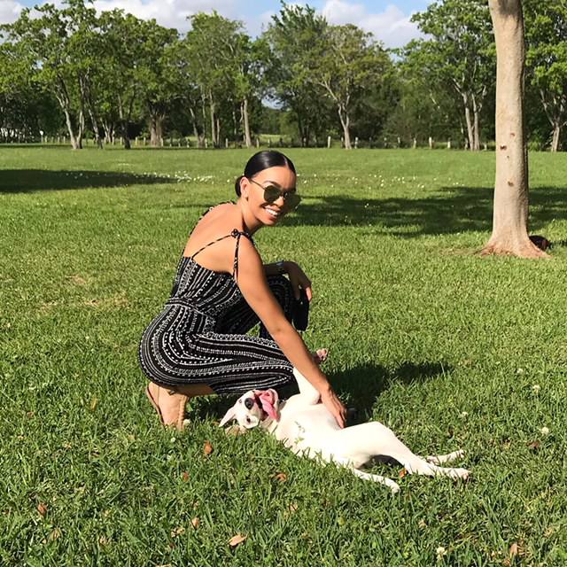 Woman and dog playing outside