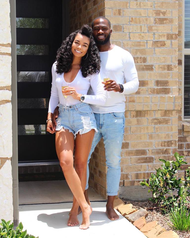 Couple outside new home
