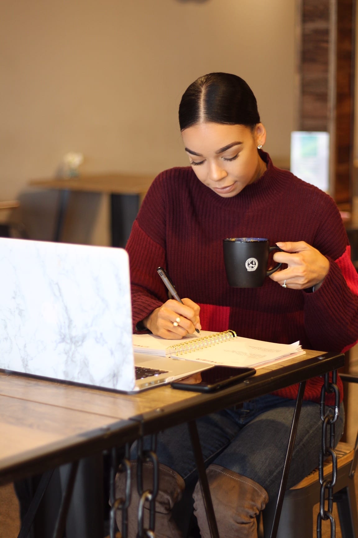 Woman working at desk with laptop.