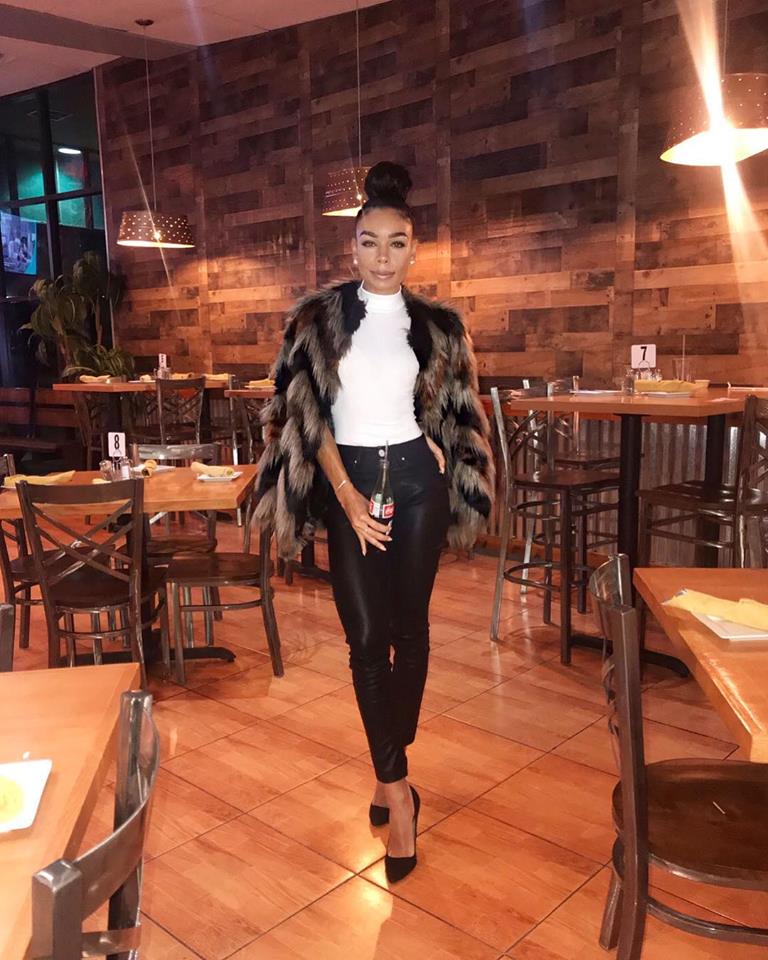 Woman in stylish outfit poses