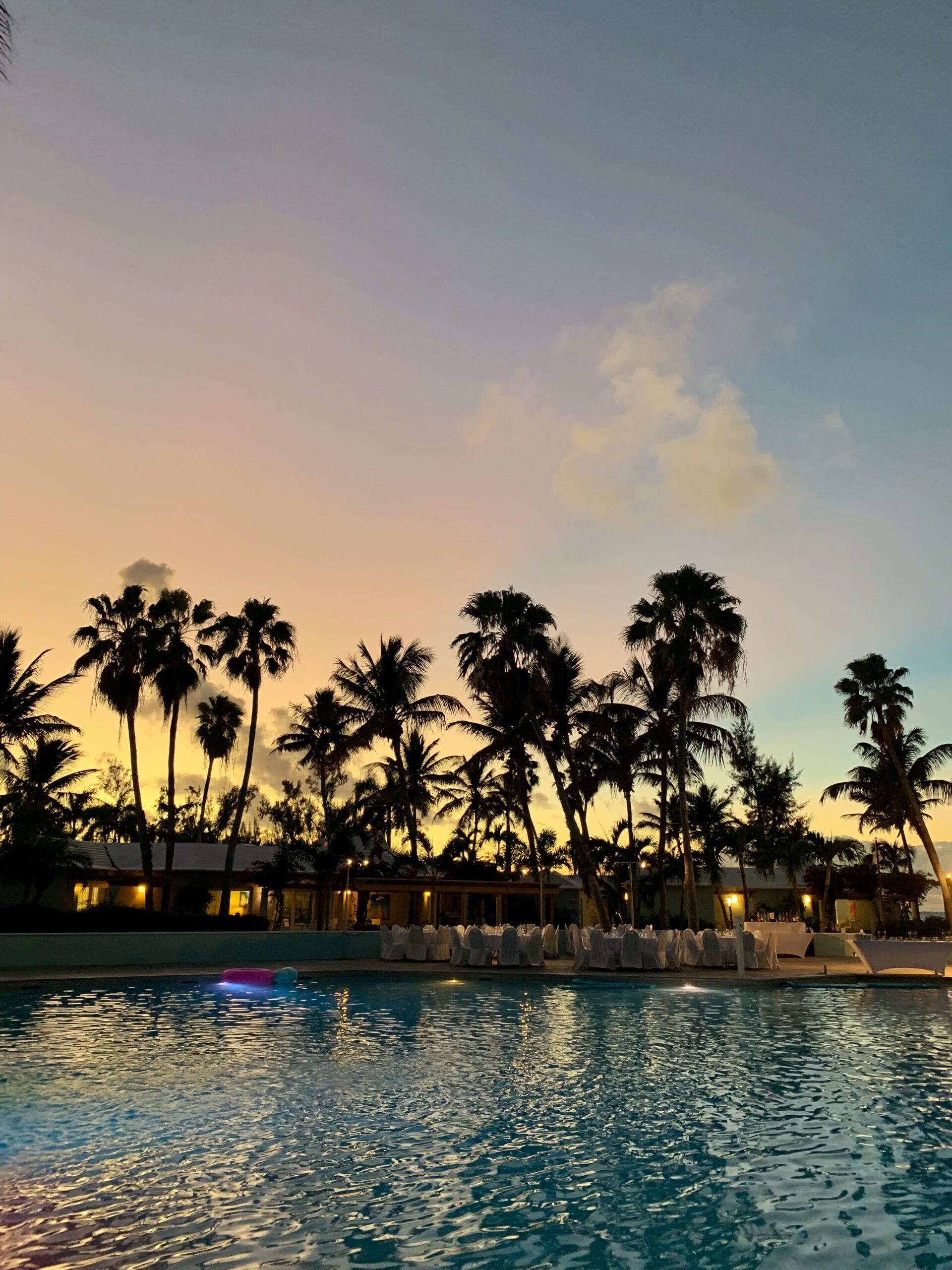 Tropical resort pool at sunset