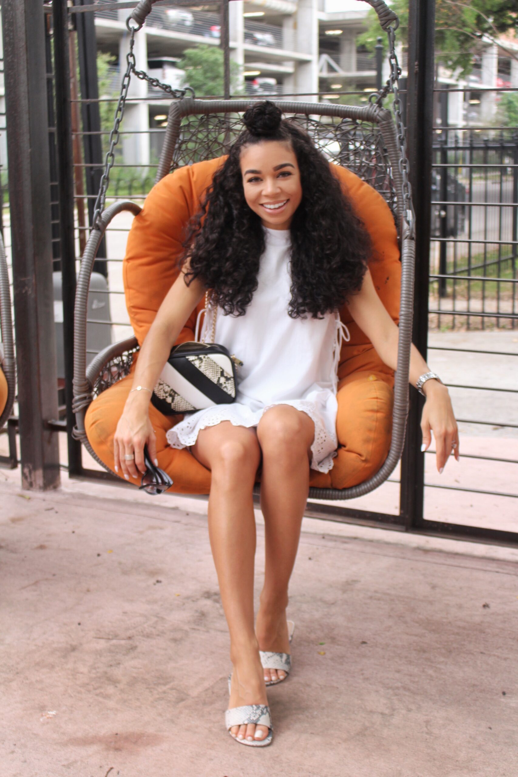 Woman on orange swing chair