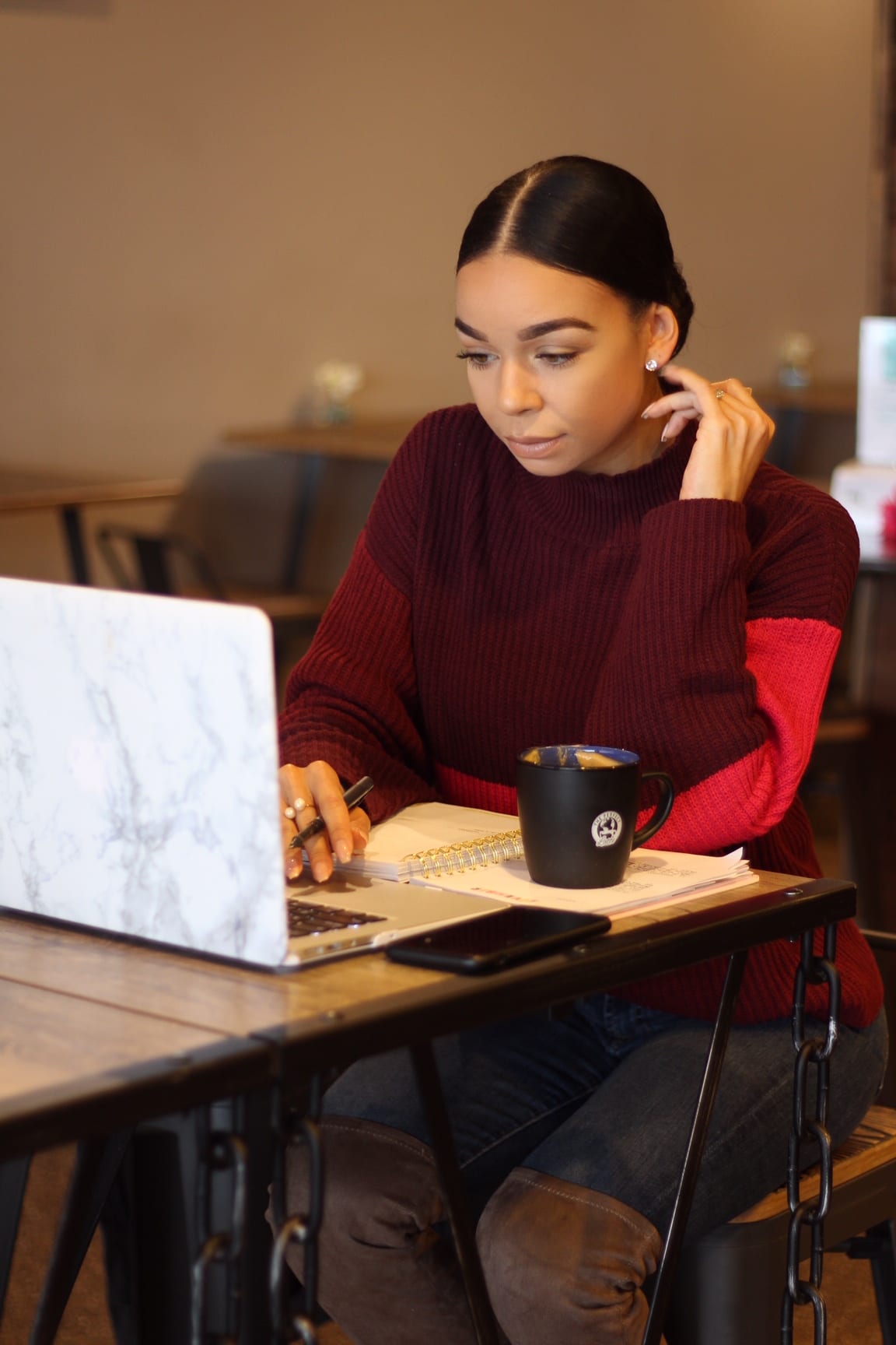 Woman working on laptop in cafe