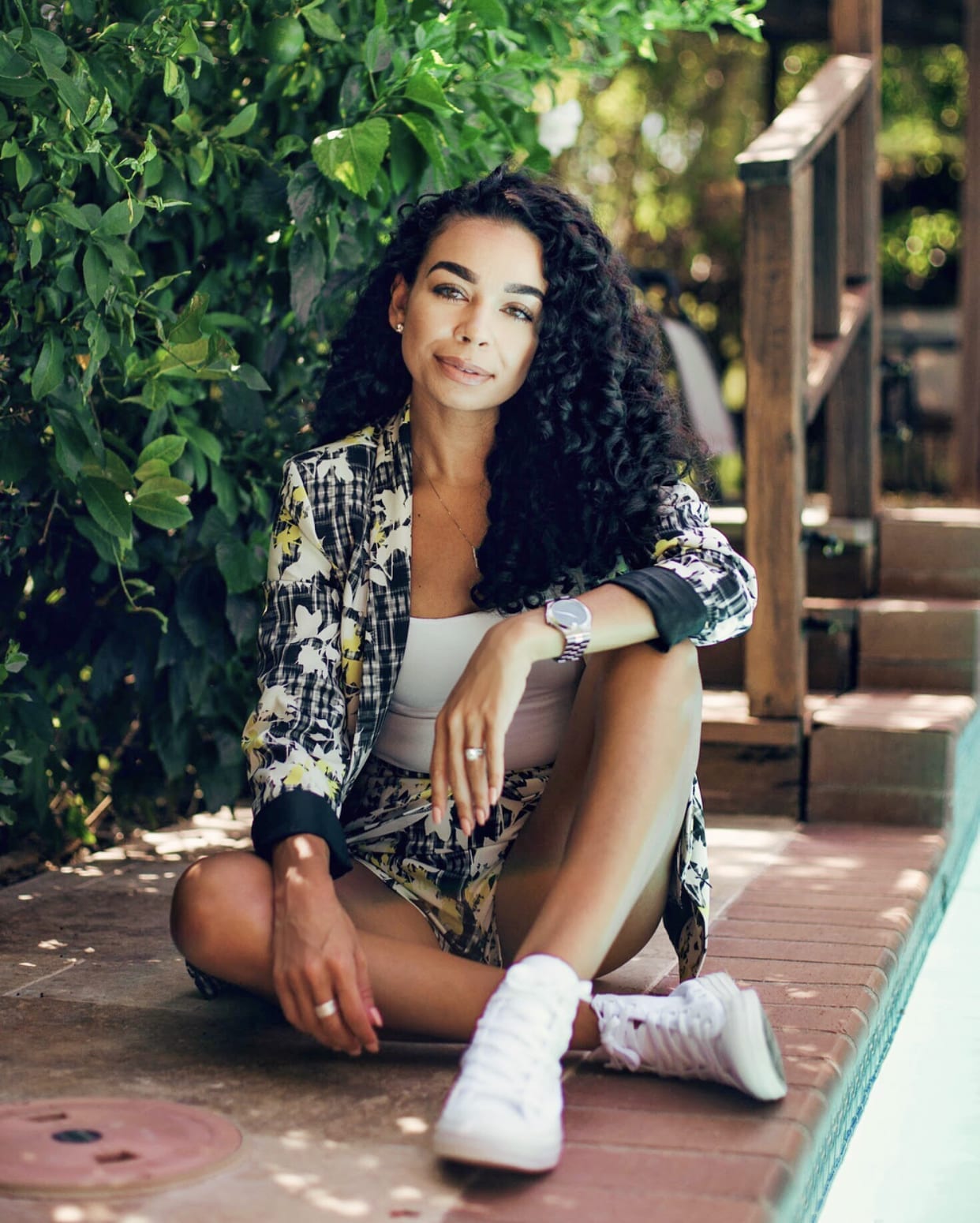 Woman in patterned blazer sitting