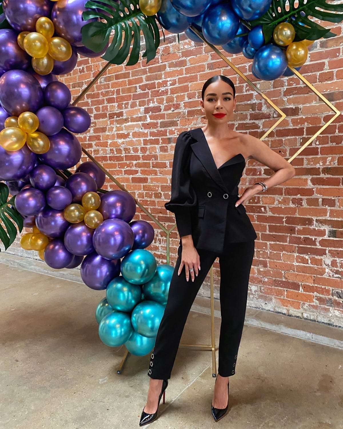 Woman in black suit poses
