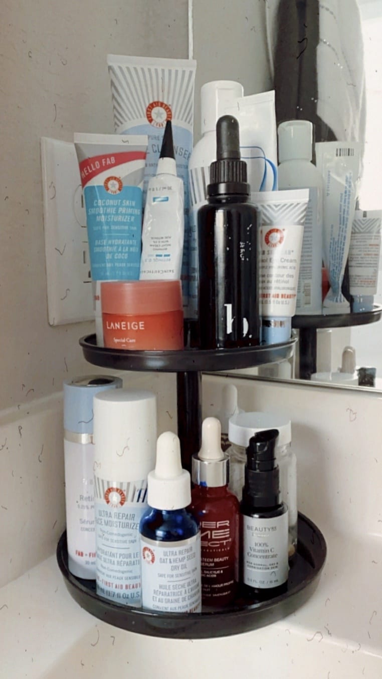 Skincare bottles on tiered stand.
