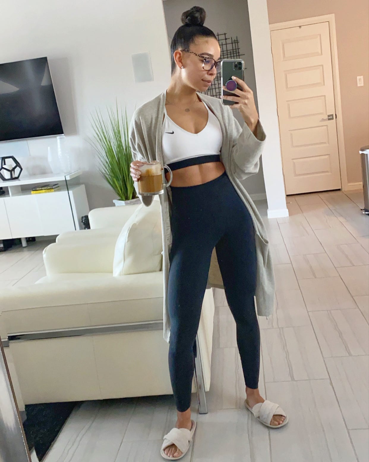 Woman in activewear holding coffee