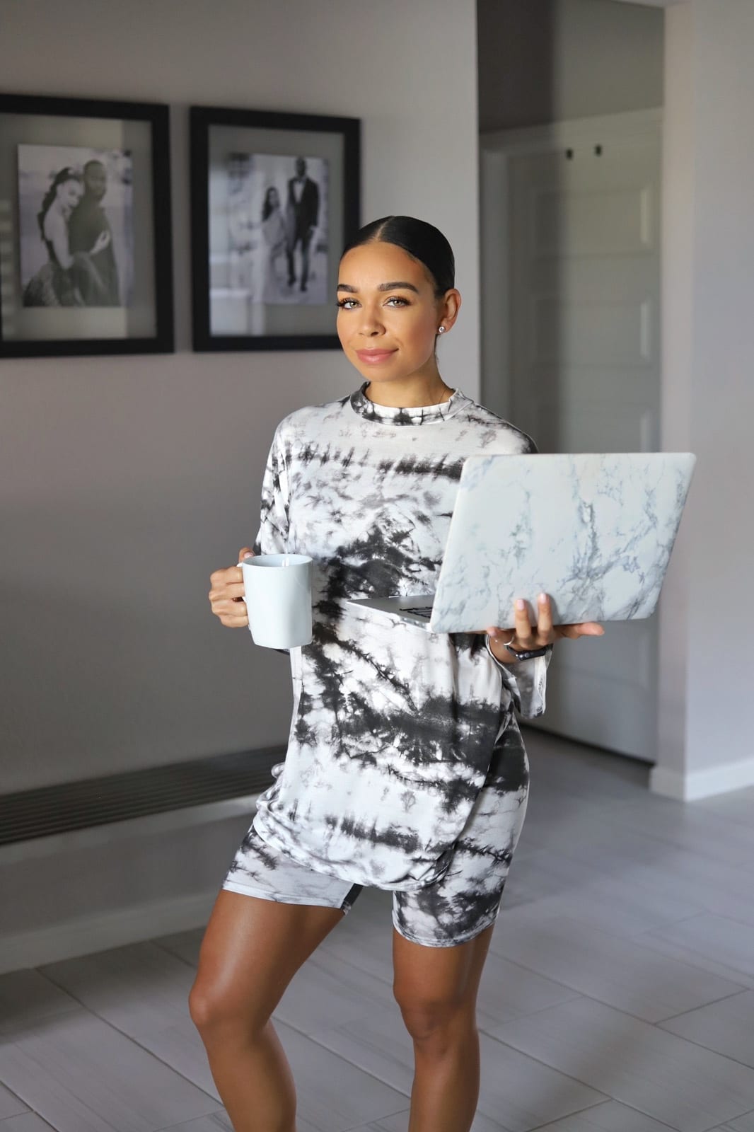 Woman holding laptop and mug